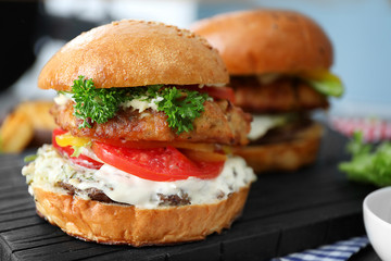 Tasty turkey burger on wooden board