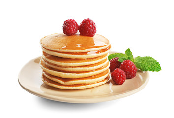 Plate with delicious pancakes on white background