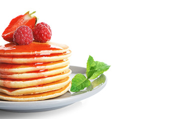 Plate with delicious pancakes on white background