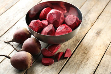 Bowl with freshly peeled beets on table