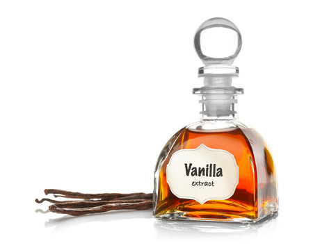 Small bottle with aromatic extract and dry vanilla beans on white background