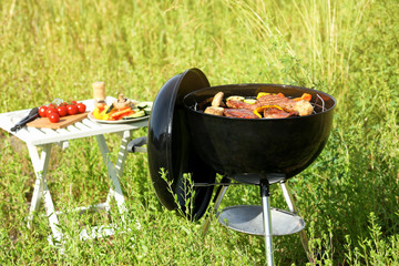 Picnic with barbecue grill outdoors