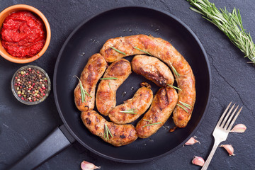 Homemade grilled sausages in pan