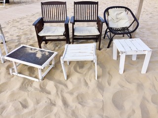 Chair, deck chair and table on the sand (Pesaro, Italy)