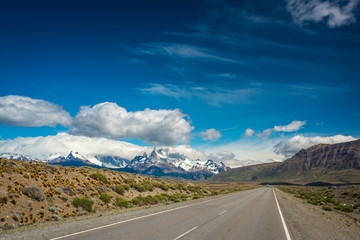 A winding asphalt road along the mountains.