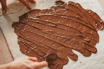 Professional confectioner making tasty cake with melted chocolate