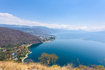 Panorama view to the village Panajachel at the lake Atitlan with amazing volcanos - Guatemala
