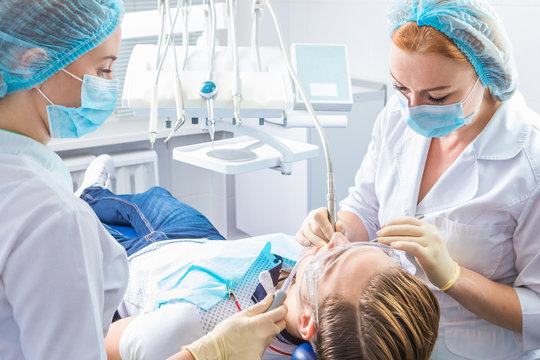 Professional dental checking and treatment. The dentist's office. Doctor and assistant for the work process
