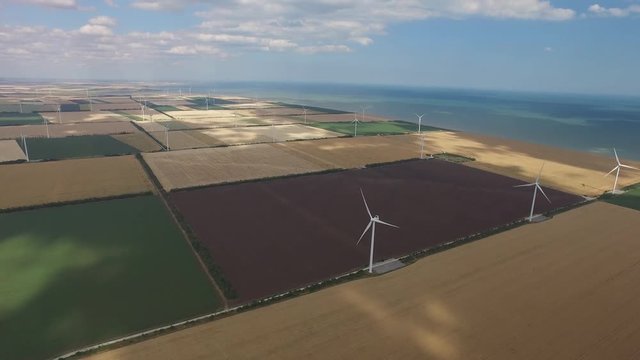 Windmills produce lot energy against a beautiful landscape. Aerial survey