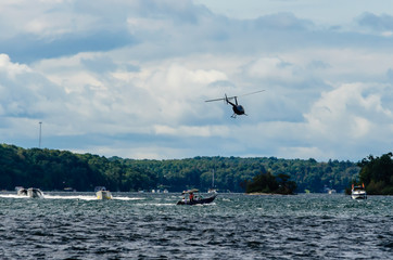 Helicopter flying away over boats on the St. Lawrence River