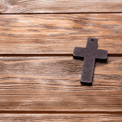 Old cross on a brown wood