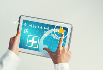 Close of female doctor hands working with tablet pc computer