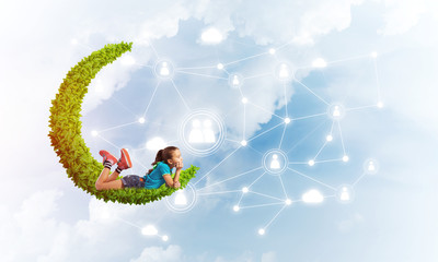 Concept of careless happy childhood with girl dreaming about something