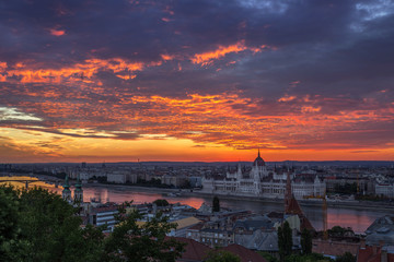Fototapeta na wymiar Budapest, Hungary - Dramatic colorful clouds and sunrise over Budapest and the Hungarian Parliament