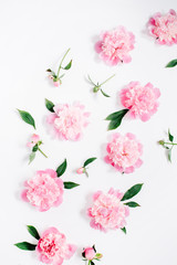 Flower pattern of pink peony flowers, branches, leaves and petals on white background. Flat lay,...