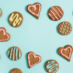 Layout with copy space made of colorful hand made cookies on blue background. Flat lay, top view.