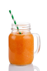 Smoothies of mango, orange and carrot isolated on white background. Freshly prepared drink made from fruits and vegetables in a glass jar
