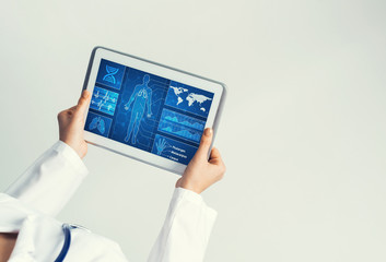 Close of female doctor hands working with tablet pc computer
