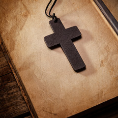 Closeup of wooden Christian cross on bible