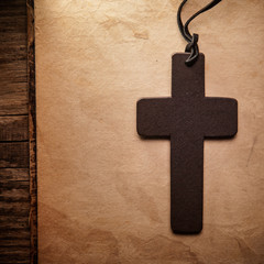 Closeup of wooden Christian cross on bible