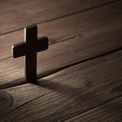 wooden cross on wood background