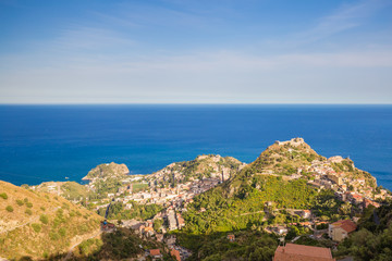 Fototapeta na wymiar Panoramic view of small Village of Castelmola, overlooking town of Taormina with sea background, Sicily island, Italy