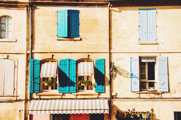 Fototapeta na wymiar Old facade with colorful shutters on the streets of Provence, France