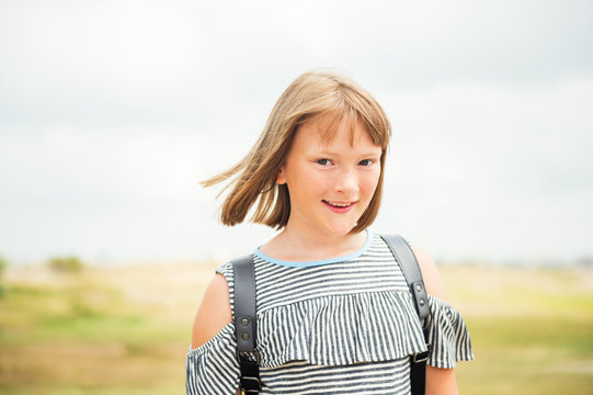 Outdoor summer portrait of sweet little girl with bob haircut