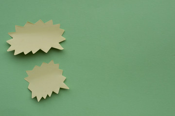 Communicaton bubble or speech bubble. Post note paper sheet or sticky sticker on green background....
