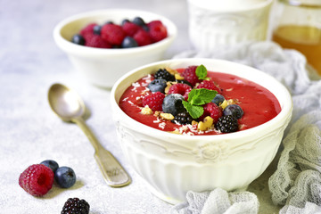 Strawberry smoothie bowl with fresh fruits and berries.