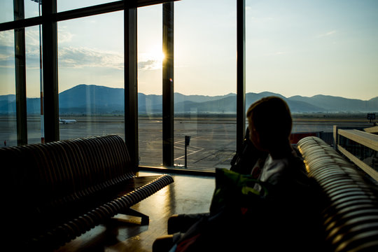 Silhouette of passenger waiting to go aboard at the airport, sunrise background