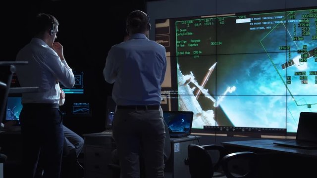 A group of people are controlling the orbiting international space station ISS. Elements of this image furnished by NASA.