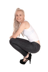 Happy blond woman crouching on floor