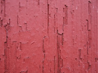 Red textured wood on the side of a building 