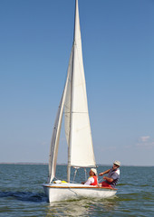 Two man drive a sport sailing yacht in competition