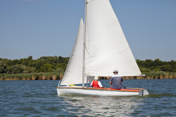 Two man drive a sport sailing yacht in competition