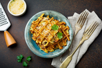 Wafers from zucchini with basil, parsley, sour cream and cheese in  ceramic plate on  dark concrete background. Selective focus.