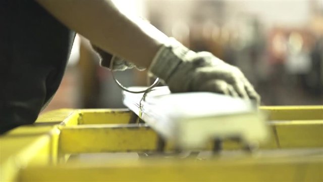 Factory Worker Wrapping A Construction Reinforcement Product - Close Up II 