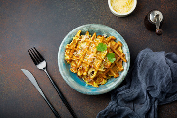 Wafers from zucchini with basil, parsley, sour cream and cheese in  ceramic plate on  dark concrete background. Selective focus.