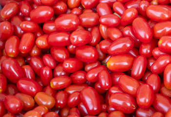 Background of lots of organic red grape tomatoes
