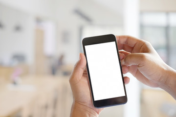 Man hands holding blank screen a smartphone and blurred background.