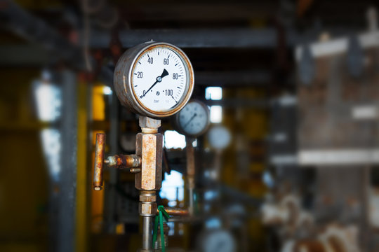 pressure gauge,pressure gauge measuring gas pressure. Pipes and valves at oil and gas industrial plant.