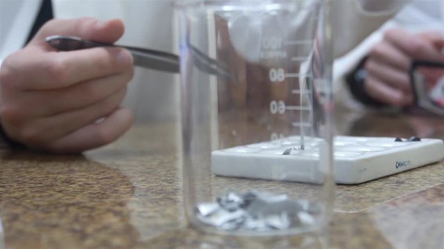 1 Chemical Measuring Cup With Hands Of Kids In Back - Focus Pull 