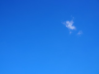 Bright blue sky with small white cloud