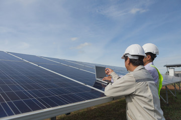 engineer working on checking and maintenance electrical equipment ; engineer inspector working on examining electrical system of solar power plant 
