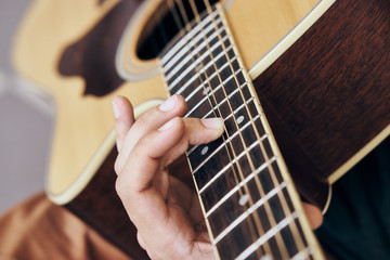 Fototapeta premium Man plays the guitar, music, musical instruments, strings