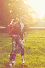 Fototapeta premium Dating couples in park at sunset