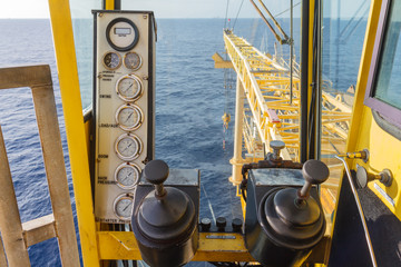 Crane cabin control to lift or move things on production platform, Energy and petroleum industry sea off shore.