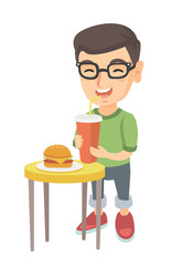 Little caucasian laughing boy in glasses drinking soda and eating cheeseburger. Smiling boy standing near the table with fast food. Vector sketch cartoon illustration isolated on white background.