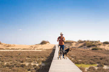 Outdoors lifestyle image of travelling man with cute dog. Tourism concept.